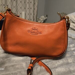 Orange leather Coach purse.